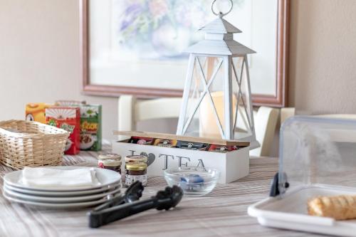 a table with plates and a toy lighthouse on it at Agriturismo Casa Rossa in Postioma