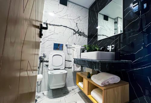 a bathroom with a white toilet and a sink at City & Stadium Luxe in Tangier