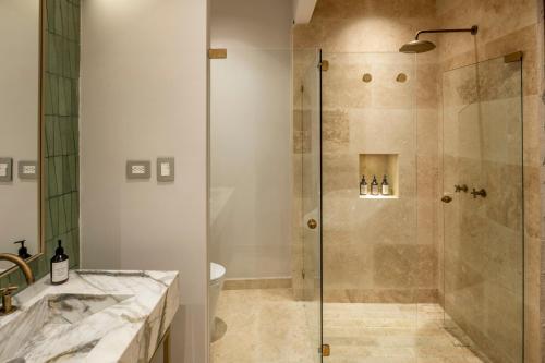 a bathroom with a shower with a glass door at Hotel Casa Sonara in Cartagena de Indias