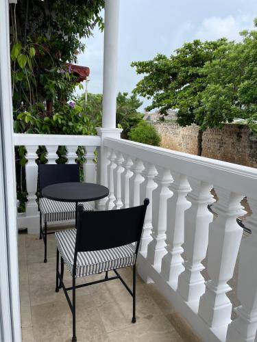 two chairs and a table on a balcony at Hotel Casa Sonara in Cartagena de Indias