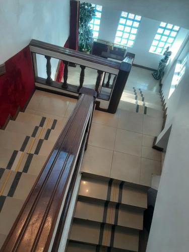 an empty escalator in a building with a bench at Lincoln Prestige Hotel in Accra