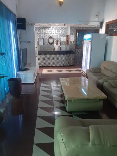 a living room with a couch and a table at Lincoln Prestige Hotel in Accra