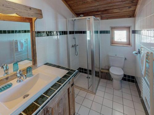 a bathroom with a sink and a shower and a toilet at Chalet de charme 14 pers. au pied des pistes avec parking, sauna et wifi - FR-1-452-108 in Les Menuires