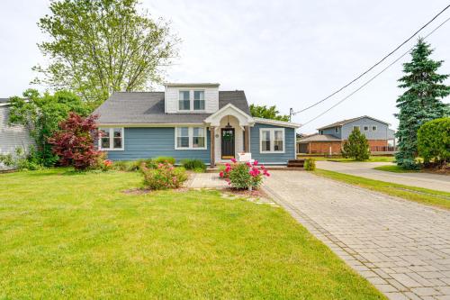 a blue house with a brick driveway at Canal-Front St Clair Shores Home 2 Mi to Dtwn in St. Clair Shores