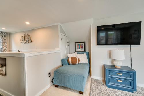 a bedroom with a blue chair and a tv at Canal-Front St Clair Shores Home 2 Mi to Dtwn in St. Clair Shores