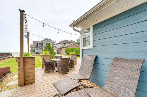 a patio with chairs and a table on a blue house at Canal-Front St Clair Shores Home 2 Mi to Dtwn in St. Clair Shores