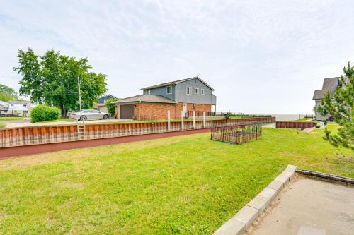a yard with a fence in front of a house at Canal-Front St Clair Shores Home 2 Mi to Dtwn in St. Clair Shores
