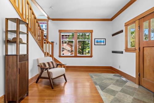 a living room with stairs and a chair at Fountain District Craftsman in Bellingham