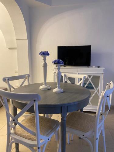 a blue table with two white vases on top of it at In centro da Cinzia in Ostuni