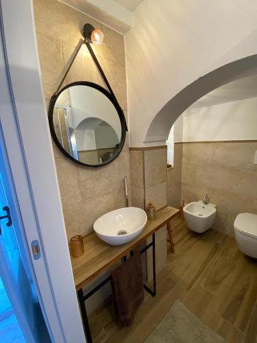 a bathroom with two sinks and a mirror at In centro da Cinzia in Ostuni