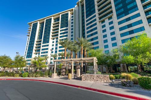 a large building with palm trees in front of a street at The Berkley, Las Vegas in Las Vegas
