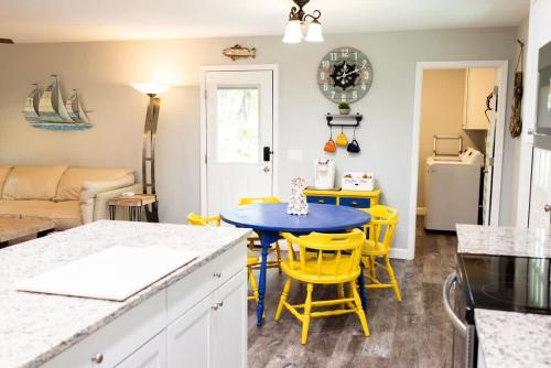 a kitchen and living room with a table and yellow chairs at Sailors Delight in Beaufort