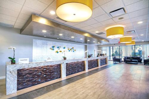 an office lobby with a reception counter with yellow lights at Wyndham Skyline Tower 2BR Apartment with Resort Access in Atlantic City