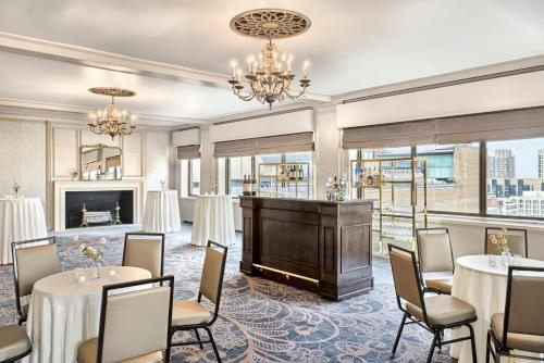 a meeting room with tables and chairs and a piano at Boston Omni Parker House Hotel in Boston