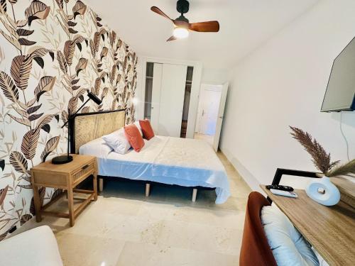 a small bedroom with a bed and a wall at T1104 - Atrium Beach 3 - 2004 Finestrat in Cala de Finestrat