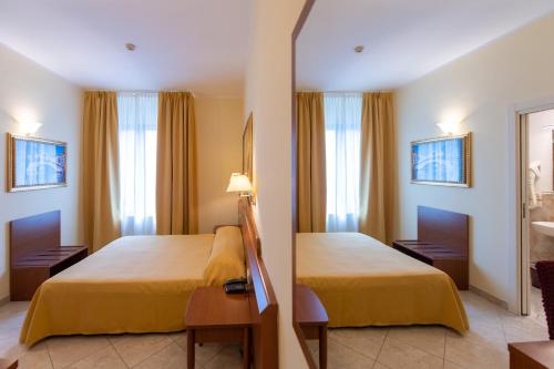 Ένα ή περισσότερα κρεβάτια σε δωμάτιο στο Hotel Ambasciata Venice - Atika & Atif