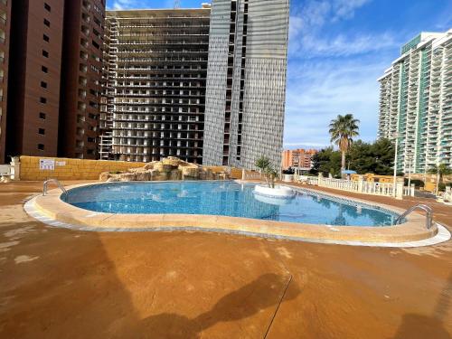 an empty swimming pool in a city with tall buildings at T1104 - Atrium Beach 3 - 2004 Finestrat in Cala de Finestrat
