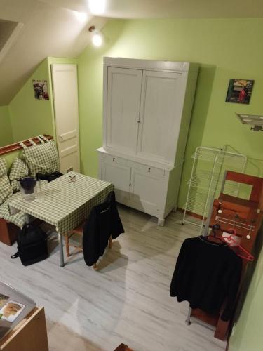a room with a table and a cabinet in a room at studio des roses in Gournay-en-Bray