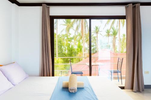 a bedroom with a bed with a view of a patio at Yayay Siargao in General Luna