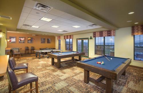 a billiard room with two pool tables and chairs at Wyndham Smoky Mountains 2BR Apartment with Resort Access in Pigeon Forge