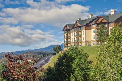 a large building on top of a hill with a road at Wyndham Smoky Mountains 3BR Apartment with Resort Access in Pigeon Forge