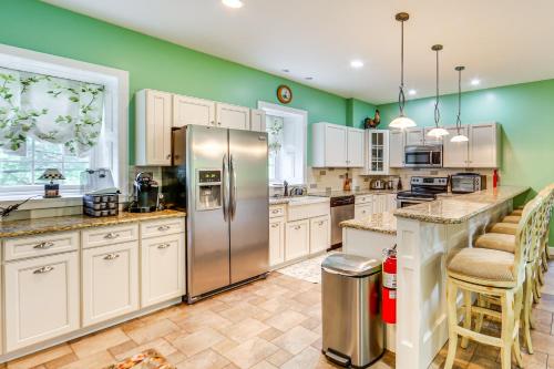 a kitchen with white cabinets and a stainless steel refrigerator at Golf Course On-Site Spacious Hollidaysburg Home! in Hollidaysburg