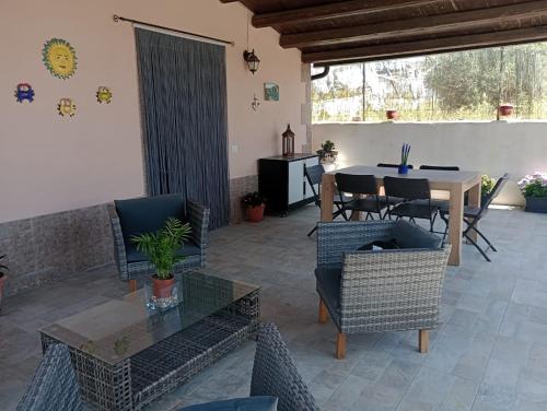 a living room with a table and chairs at Cirica Relax in Santa Maria Del Focallo