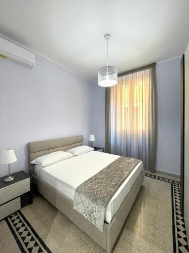 a bedroom with a large bed and a window at Casa Vacanze Il Corallo in Anzio