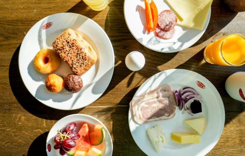 a table with three plates of food on it at Hotel Limfjorden in Thisted