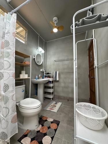 a bathroom with a toilet and a sink at 29 Palms Thailand in Ban Klang