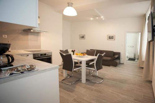 a kitchen and dining room with a table and chairs at Old Square Apartment in Split