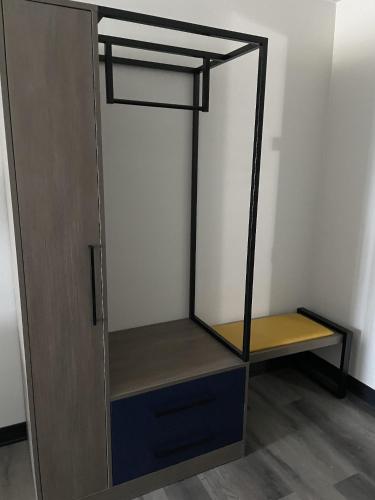 a closet with a wooden door and a shelf at Dakota Inn in Minot