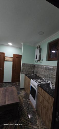 a kitchen with a stove and a counter top at Maria in Yerevan