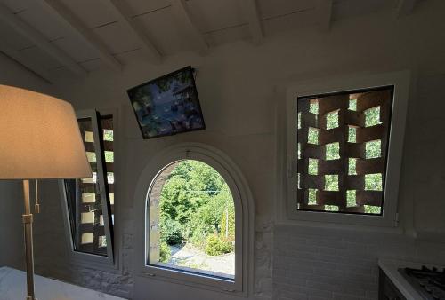 a room with an arched window and a room with a window at The Relax Barn in San Casciano in Val di Pesa