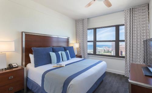 a bedroom with a large bed and a large window at Wyndham Skyline Tower 2BR Apartment with Resort Access in Atlantic City