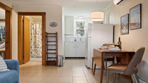 a kitchen and dining room with a table and a refrigerator at Beachside Oceanside Walk onto the beach in Saco