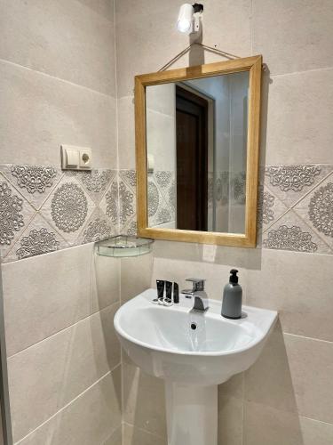 a bathroom with a sink and a mirror at Guest House Keti Margiani Mestia in Mestia