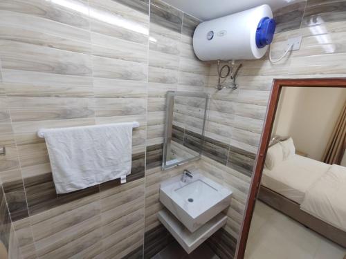 a bathroom with a sink and a mirror at Al Anwar Building Luxury in Salalah