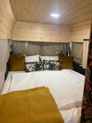 a large white bed in a room with wooden walls at Casa das Fontes O Tocano in Válega