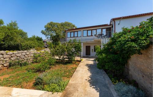 a house with a stone wall next to a yard at 3 Bedroom Gorgeous Apartment In Seline in Seline