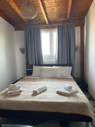 a bed with two towels on it with a window at Astri Villa in Ierissos
