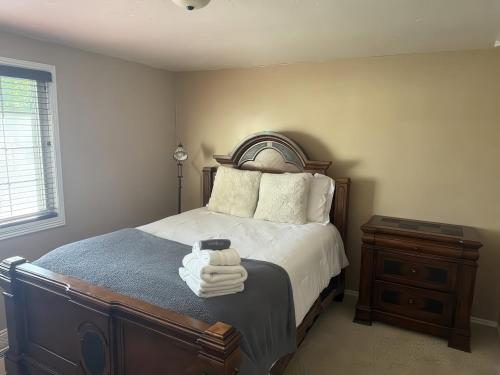 MillcreekにあるCharming Mountain Retreat with Enclosed Backyard and Artistic Flairのベッドとタオル2枚のある寝室