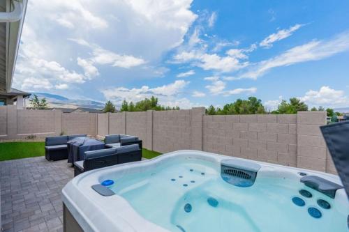 a hot tub in the backyard of a house at Stylish Revival Retreat w Hot Tub and Fire Pit in Cottonwood