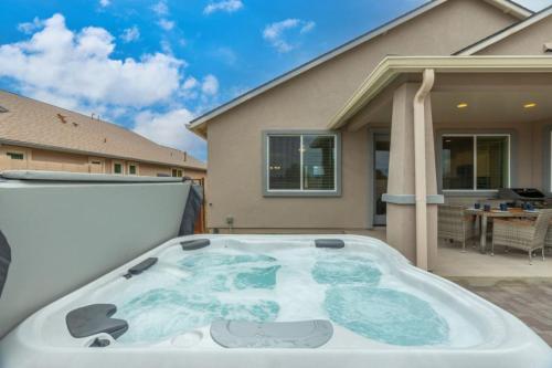 a hot tub on the back of a backyard at Stylish Revival Retreat w Hot Tub and Fire Pit in Cottonwood