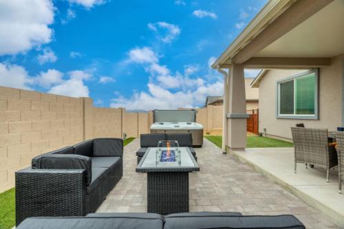 a patio with a couch and a table at Stylish Revival Retreat w Hot Tub and Fire Pit in Cottonwood