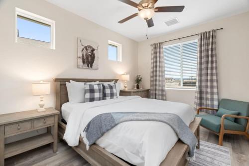 a bedroom with a bed and a chair and a window at Stylish Revival Retreat w Hot Tub and Fire Pit in Cottonwood