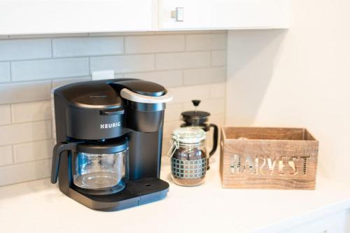 a coffee maker on a kitchen counter with a box at Stylish Revival Retreat w Hot Tub and Fire Pit in Cottonwood