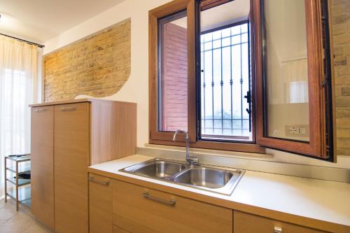 a kitchen with a sink and a window at B&B Porta Della Noce in Lanciano