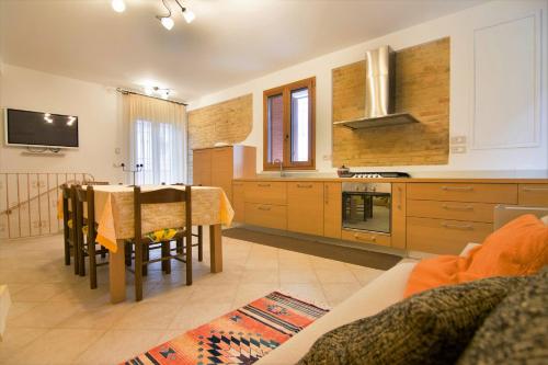 a kitchen with a table and a dining room at B&B Porta Della Noce in Lanciano