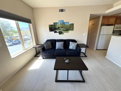 a living room with a couch and a table at Condo on Wolf Creek Golf Course in Mesquite